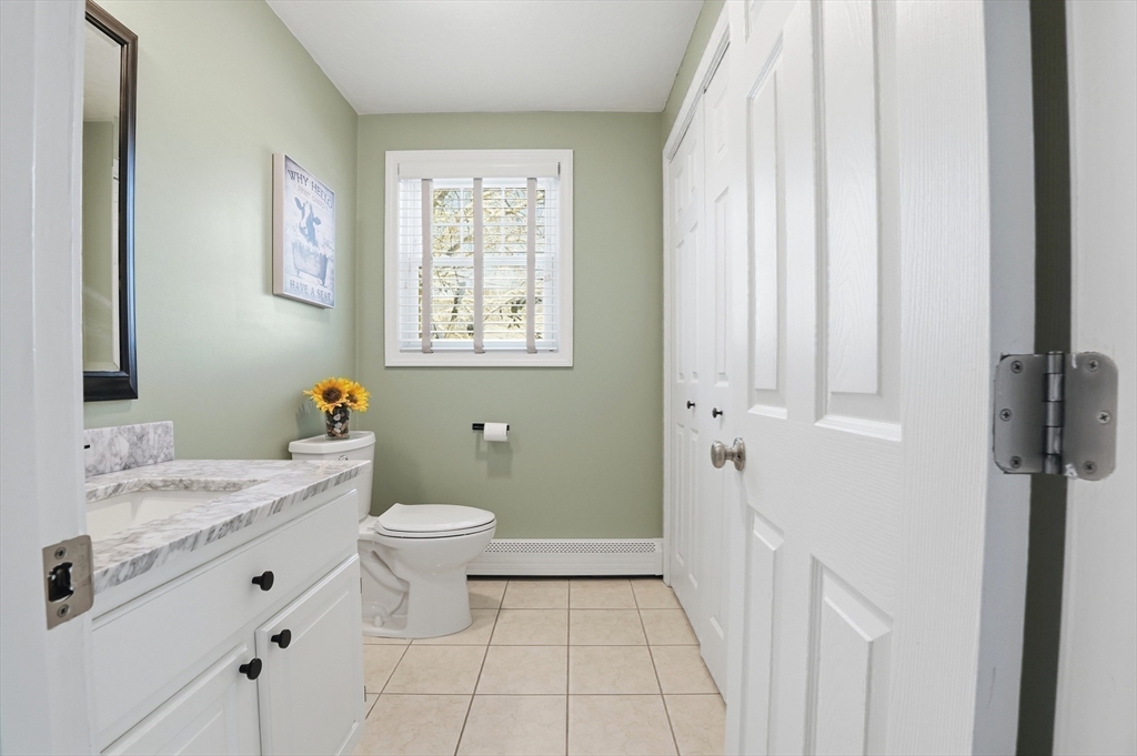 174 Columbus Drive Fall River, MA 02720 - Photo 21 of 33 a bathroom with a granite countertop sink toilet and shower curtains