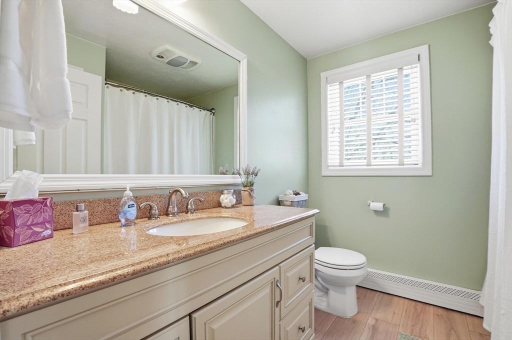 174 Columbus Drive Fall River, MA 02720 - Photo 24 of 33 a bathroom with a granite countertop sink a mirror and a toilet