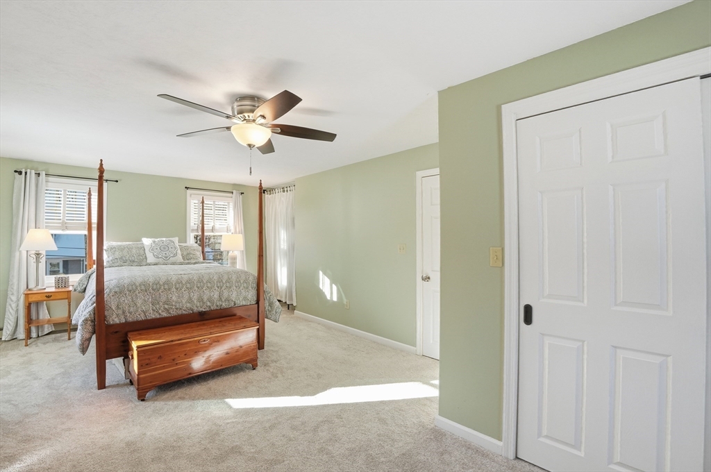 174 Columbus Drive Fall River, MA 02720 - Photo 26 of 33 a bedroom with a bed and a chandelier