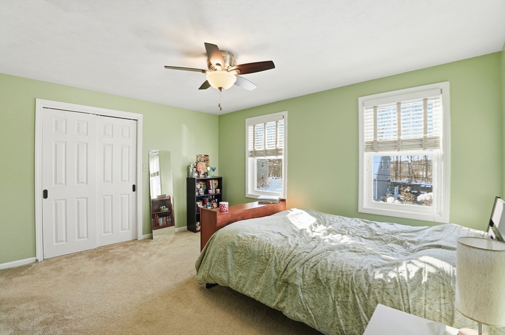 174 Columbus Drive Fall River, MA 02720 - Photo 27 of 33 a spacious bedroom with a bed and a chandelier