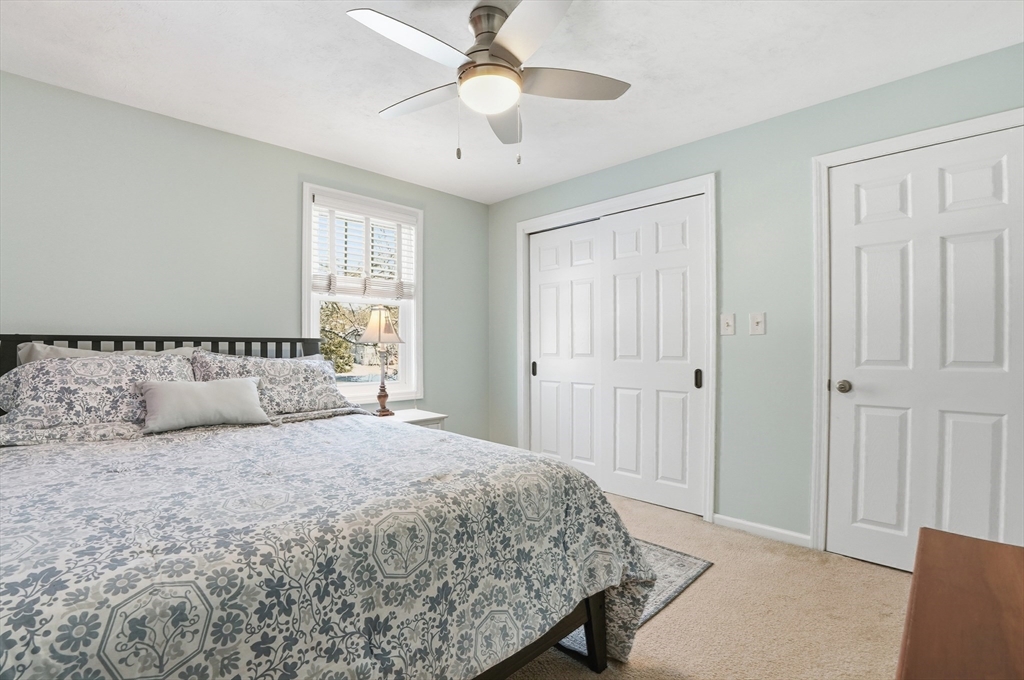 174 Columbus Drive Fall River, MA 02720 - Photo 29 of 33 a bedroom with a large bed and a chandelier
