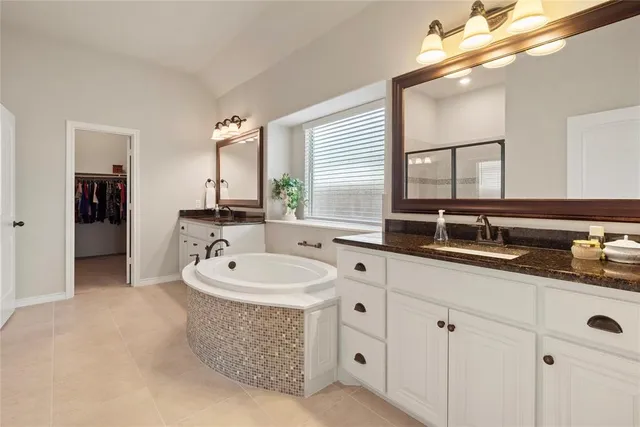 a bathroom with a sink double vanity and a mirror