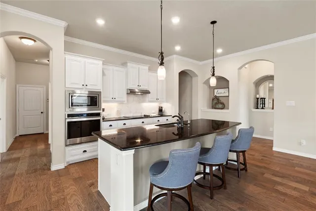 a kitchen with a table and chairs in it