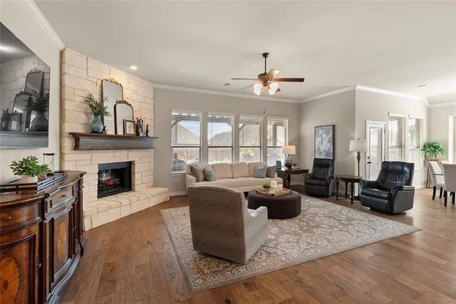 a living room with fireplace furniture and a wooden floor