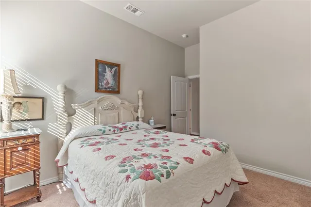 a bedroom with a bed and a table