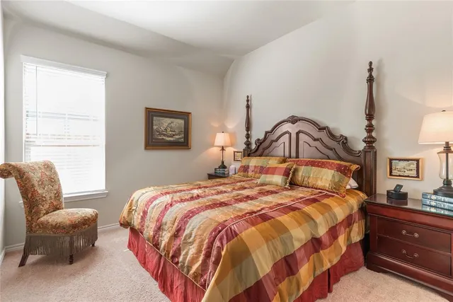 a bedroom with a bed a couch and dresser