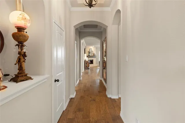 a view of a hallway to a livingroom with wooden floor