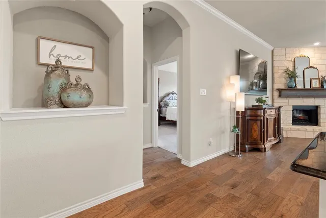 a view of a hallway with wooden floor and a living room