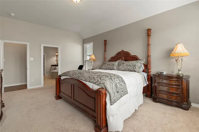 a bed room with a bed and a lamp