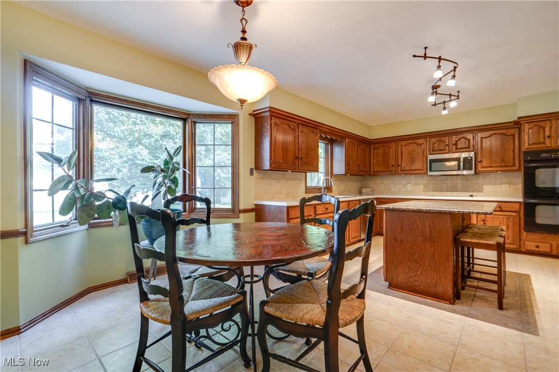 3465 Bancroft Road Akron, OH 44333 - Photo 15 of 50 Dining space with light tile patterned floors and baseboards