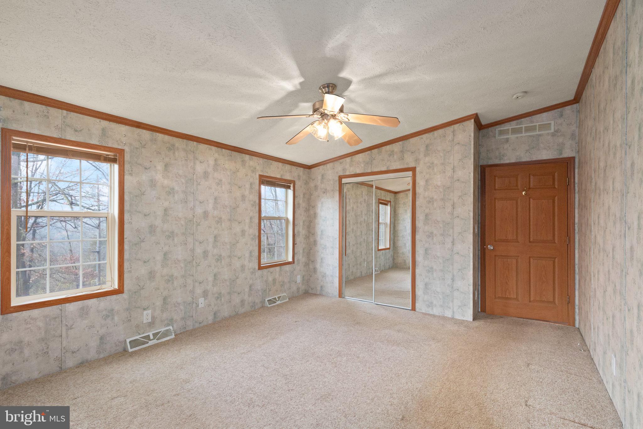 16 High Ridge Road Delta, PA 17314 - Photo 11 of 32 an empty room with chandelier fan and windows