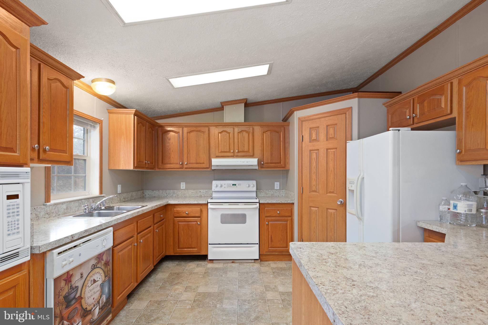 16 High Ridge Road Delta, PA 17314 - Photo 3 of 32 a kitchen with a sink stove and refrigerator