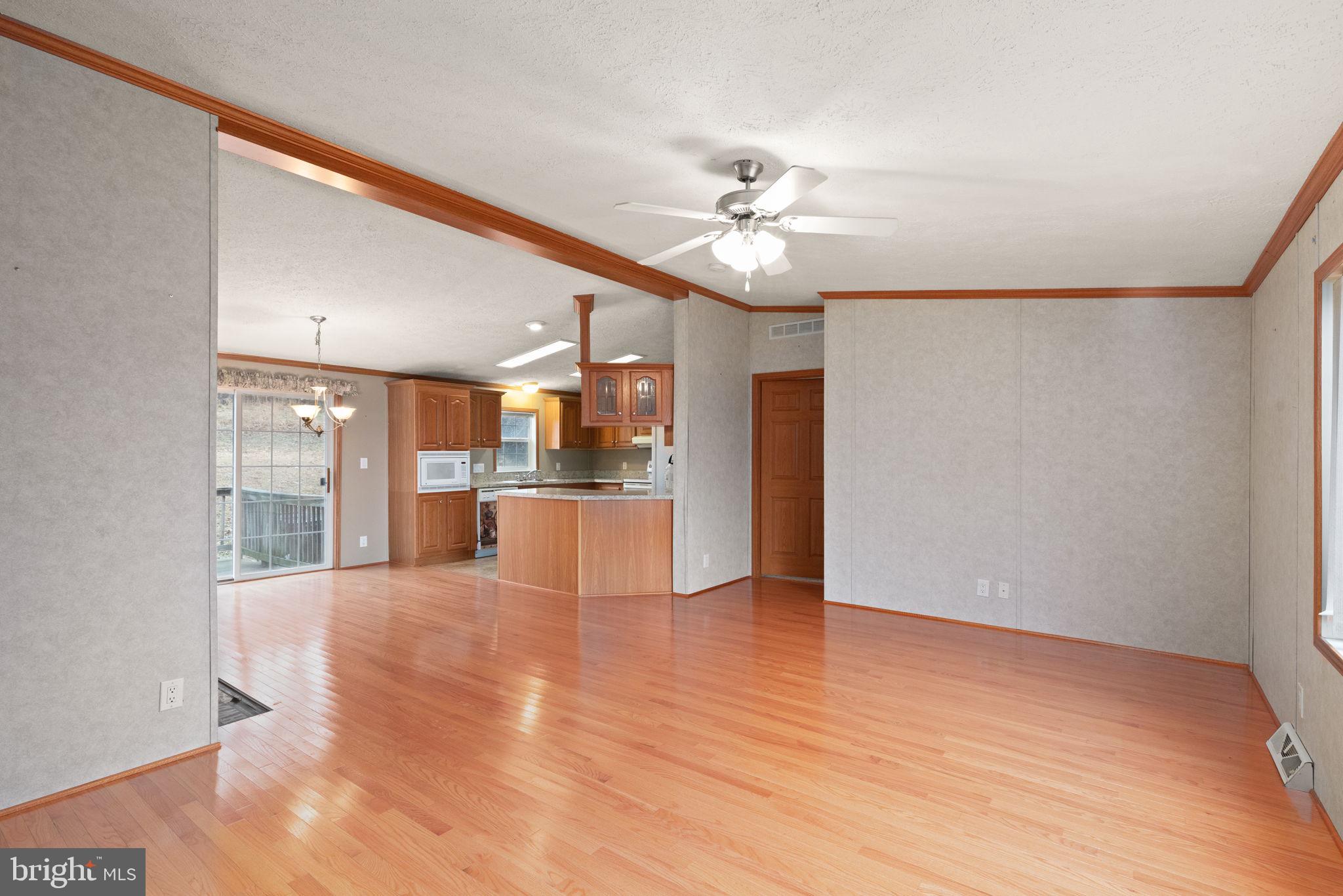 16 High Ridge Road Delta, PA 17314 - Photo 7 of 32 a view of a hallway with wooden floor and a kitchen