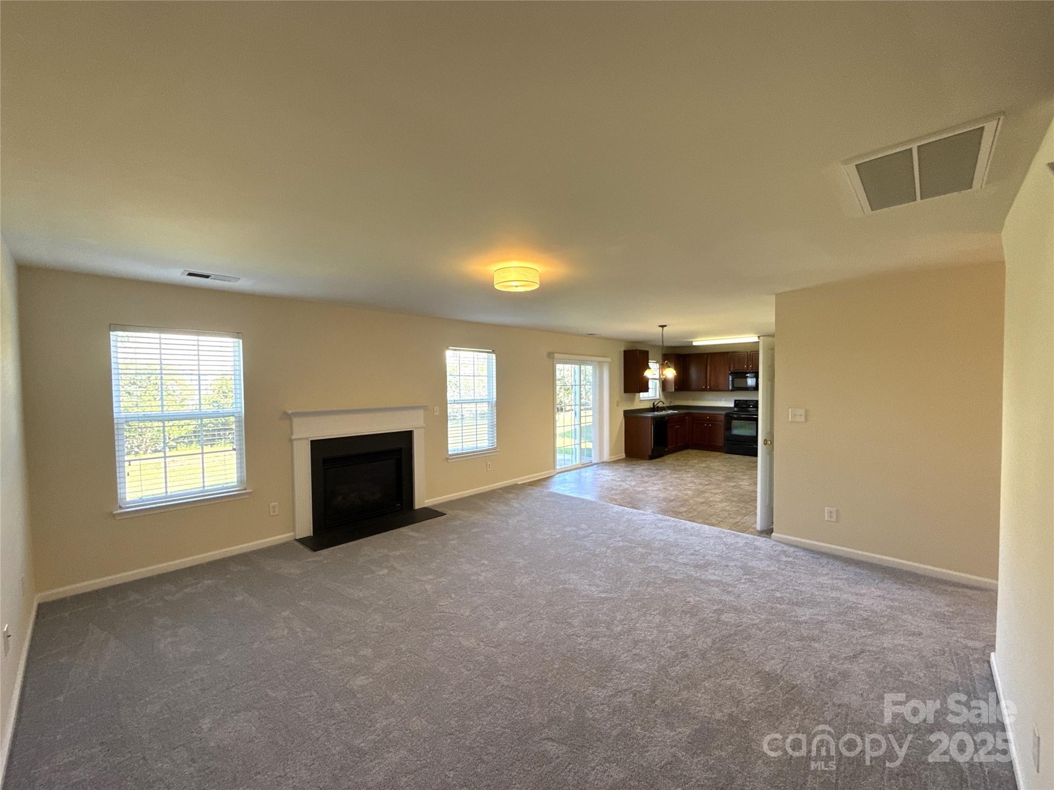 1484 Haverford Road Northwest Concord, NC 28027 - Photo 11 of 33 a view of a livingroom with a fireplace and window