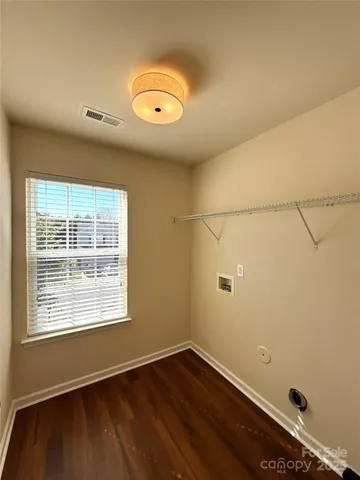 a view of a house with street next to a road