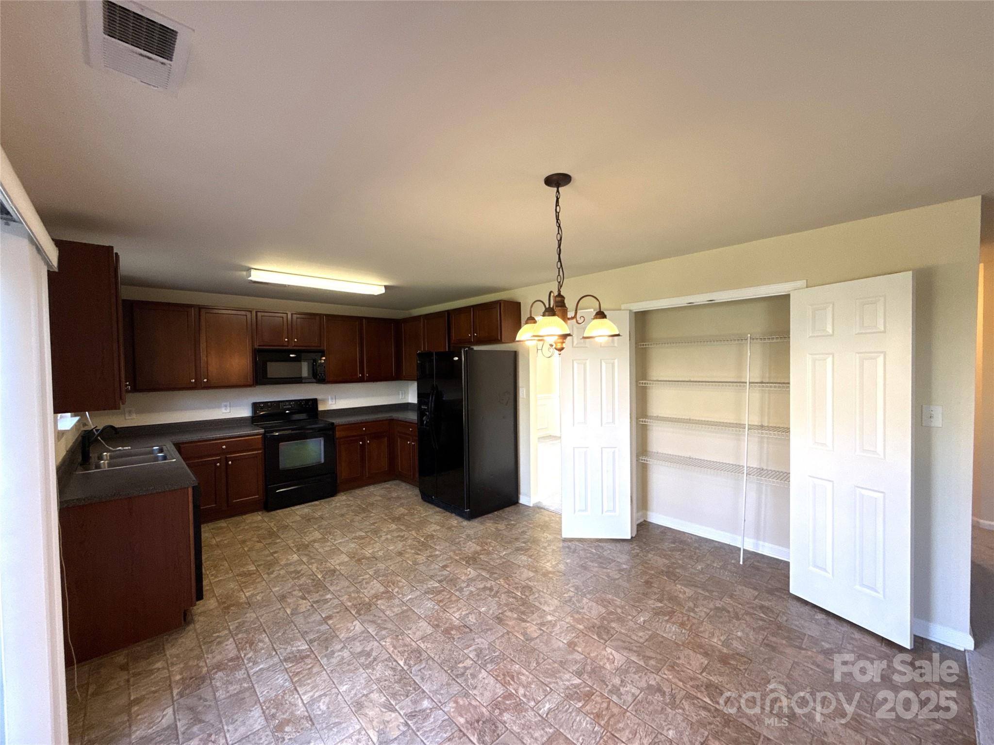 1484 Haverford Road Northwest Concord, NC 28027 - Photo 8 of 33 a kitchen with refrigerator and window