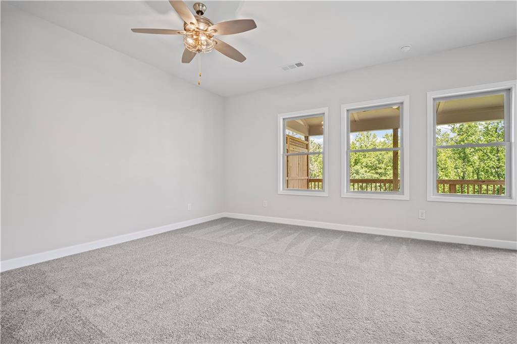 203 Retreat Lane Canton, GA 30114 - Photo 17 of 47 an empty room with windows and fan
