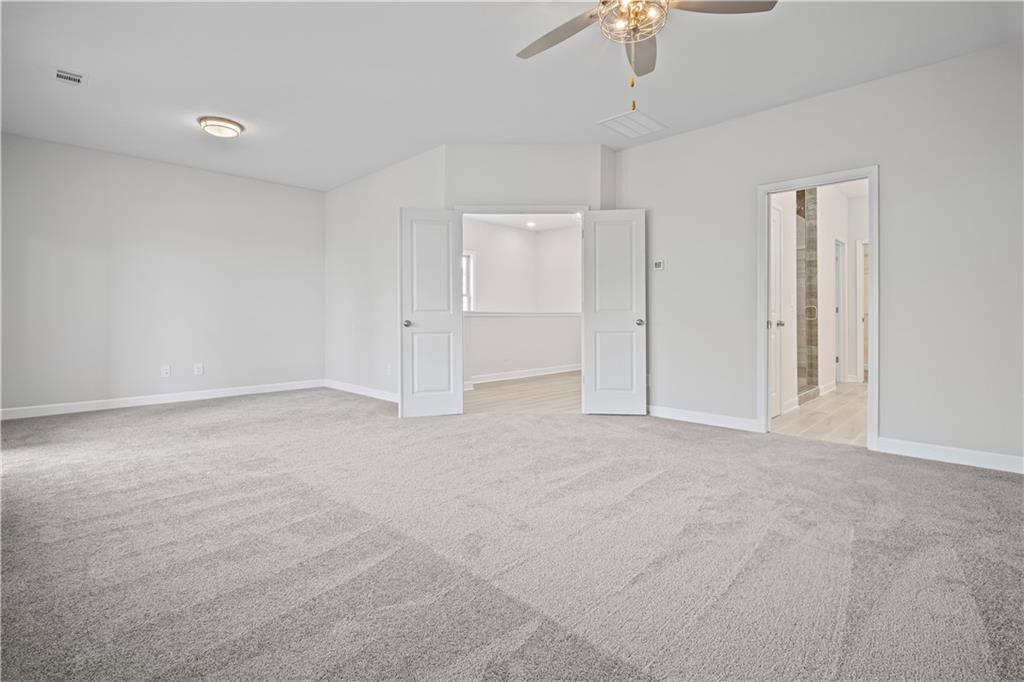 203 Retreat Lane Canton, GA 30114 - Photo 18 of 47 a view of an empty room with a ceiling fan