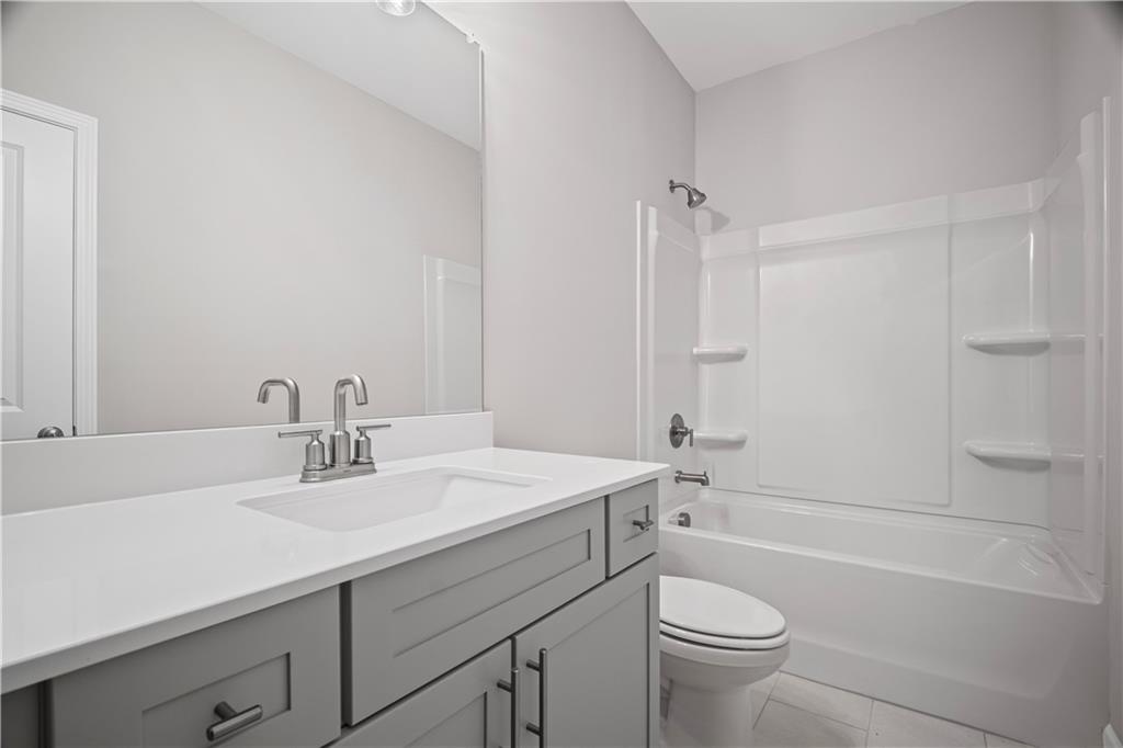 203 Retreat Lane Canton, GA 30114 - Photo 27 of 47 a bathroom with a sink a toilet and shower