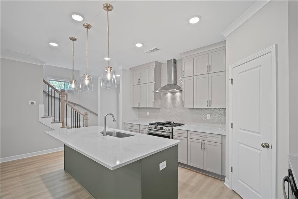 203 Retreat Lane Canton, GA 30114 - Photo 7 of 47 a kitchen with stainless steel appliances a sink a stove a refrigerator and white cabinets