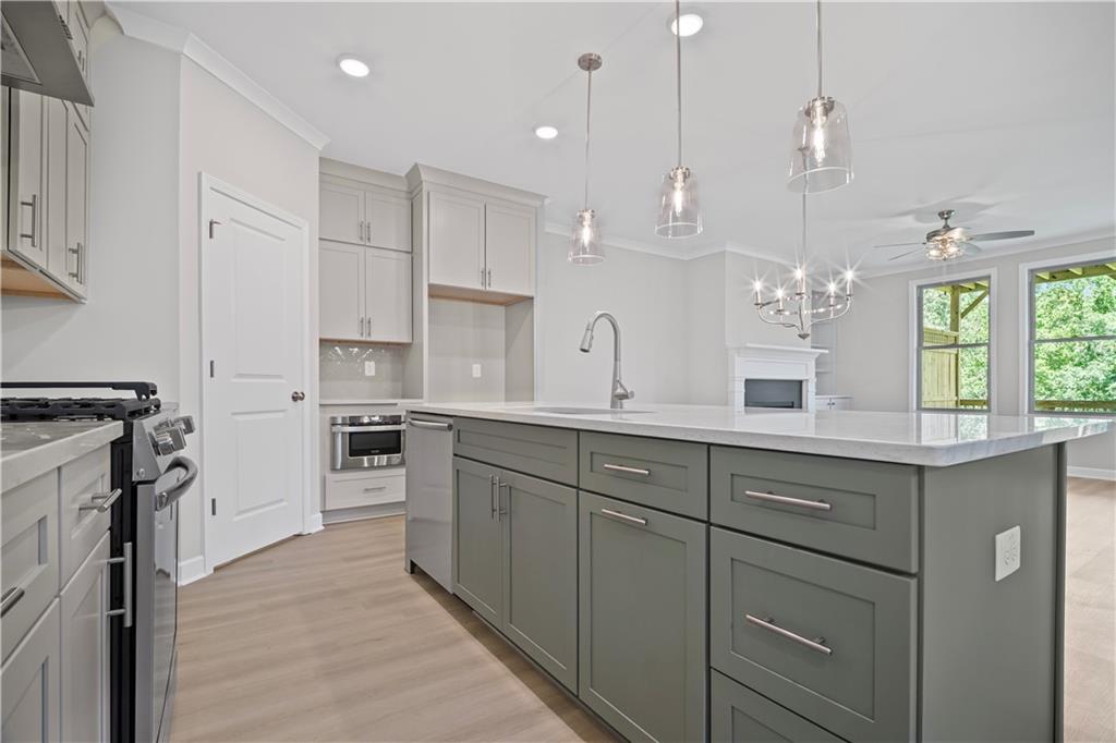203 Retreat Lane Canton, GA 30114 - Photo 10 of 47 a large kitchen with white cabinets and stainless steel appliances