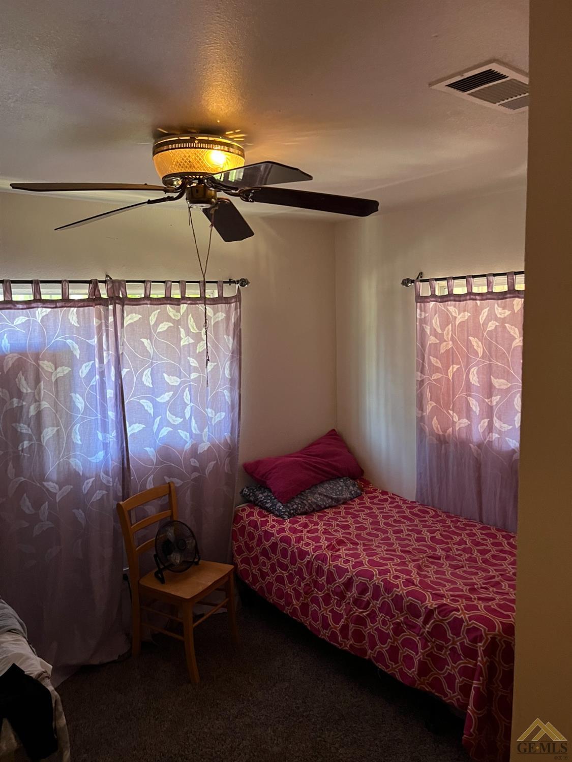 Undisclosed Address Delano, CA 93215 - Photo 6 of 9 a bedroom with a bed and a mirror on the wall