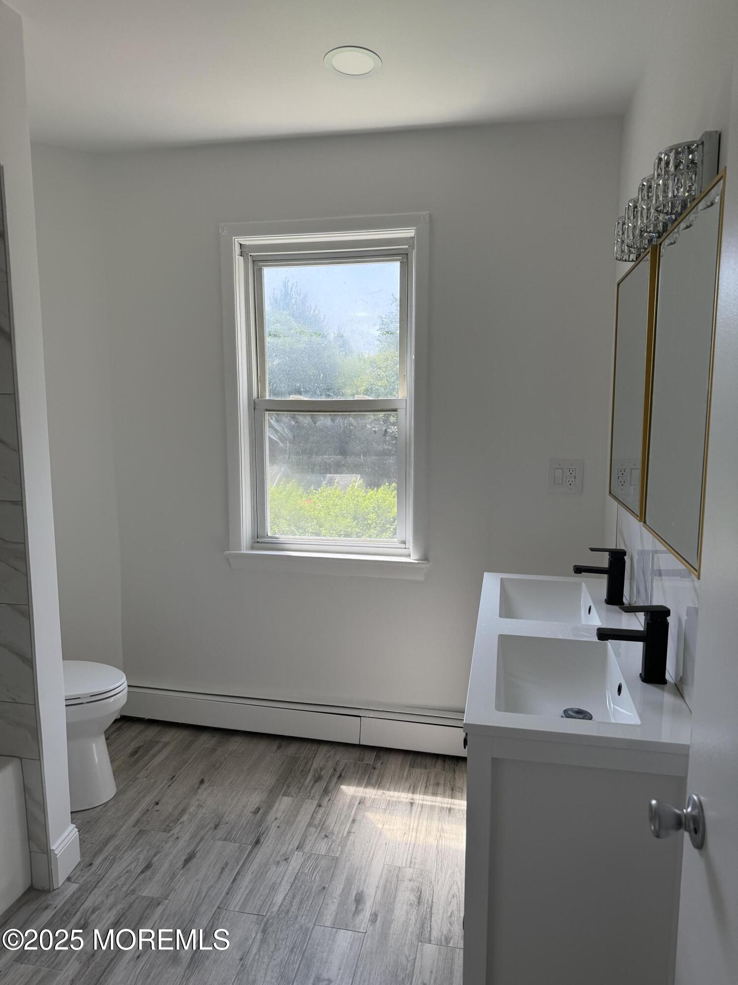 140 Franklin Avenue, Unit 3 Long Branch, NJ 07740 - Photo 9 of 14 a bathroom with a sink a toilet and a mirror