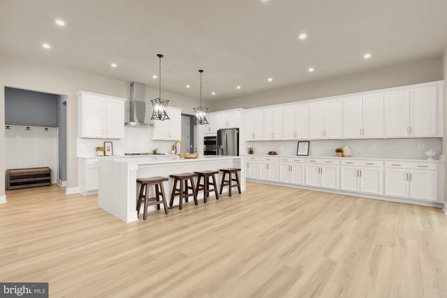 a kitchen with stainless steel appliances a sink stove and refrigerator