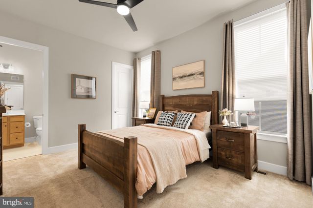 a bedroom with a bed chair and window