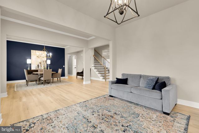 a living room with furniture and a dining table with kitchen view