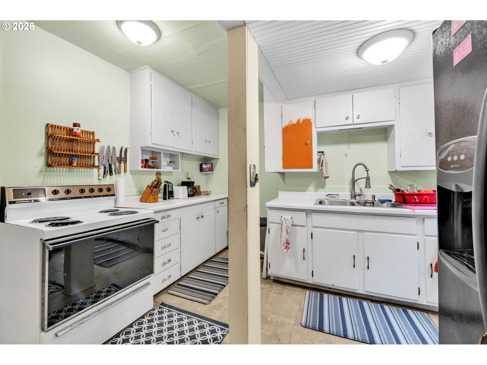 47054 Westfir-Oakridge Road Westfir, OR 97492 - Photo 11 of 28 a kitchen with stainless steel appliances a stove a sink a chimney and cabinets