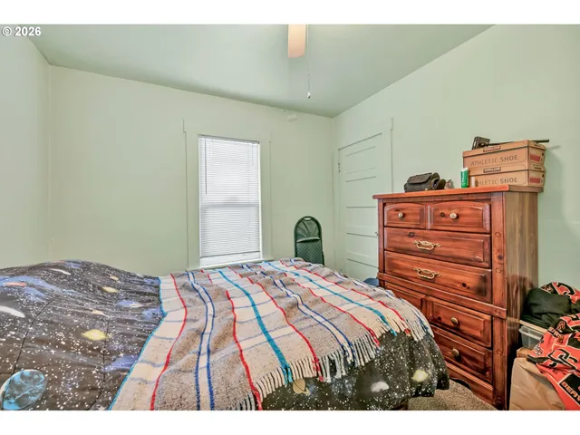 a bedroom with a bed and a dresser