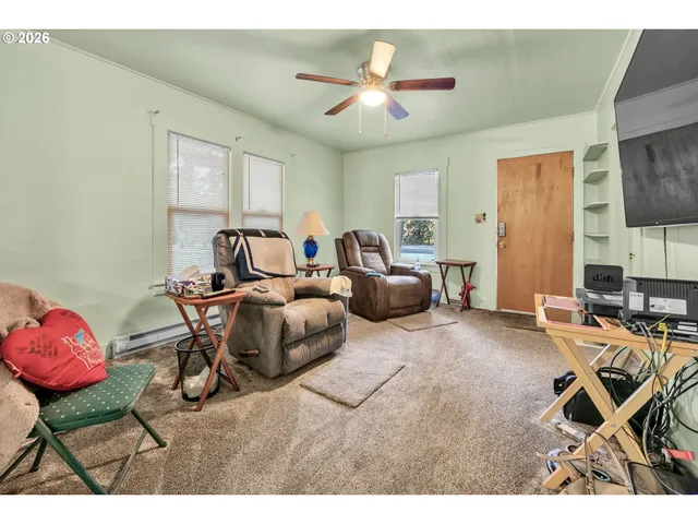 a living room with furniture a air conditioner vent and a window