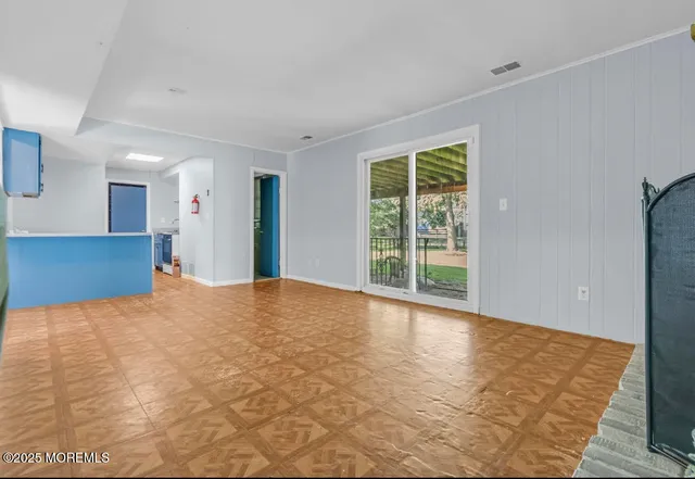 a view of a big room with windows and closet