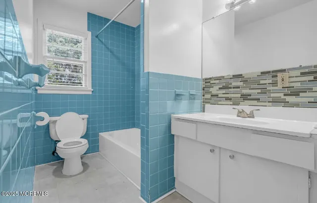 a bathroom with a sink toilet and vanity
