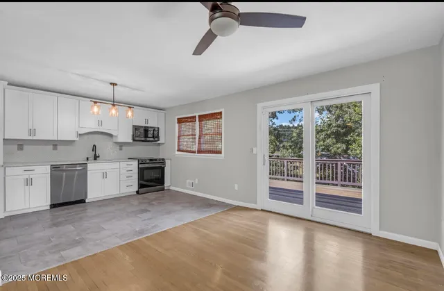 a view of a kitchen with electric appliances