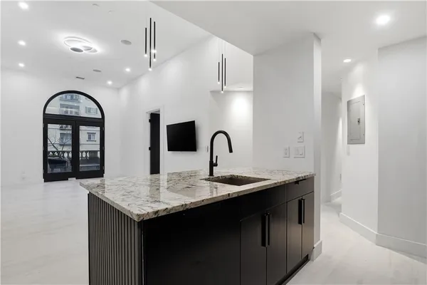 a kitchen with sink and mirror