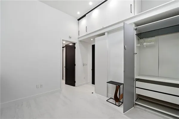 a view of a livingroom with a flesh screen tv and stairs
