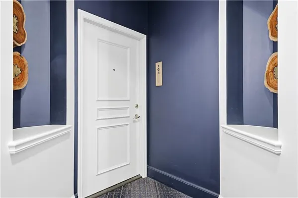 a kitchen with stainless steel appliances kitchen island granite countertop a table chairs in it and wooden floors