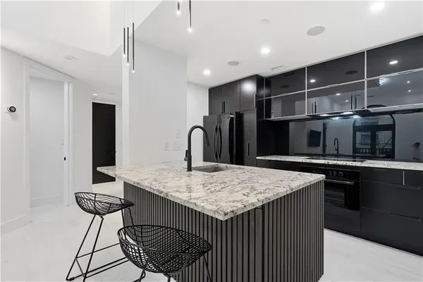 a kitchen with stainless steel appliances granite countertop a sink stove and refrigerator