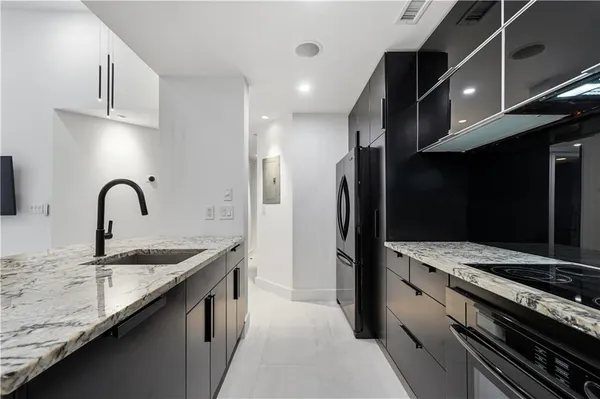 a kitchen that has a sink and a stove