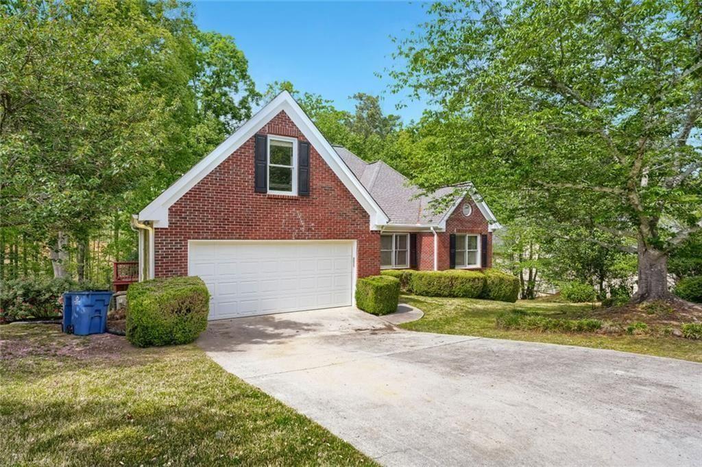 2128 Cluster Lane Grayson, GA 30017 - Photo 3 of 40 a view of a house with a yard and large trees