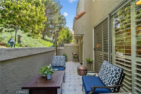 a view of balcony with chair and potted plant