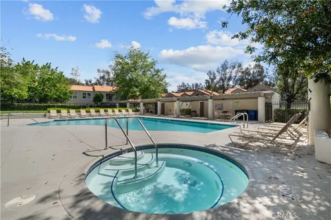 a swimming pool with outdoor seating yard and barbeque oven