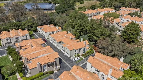 an aerial view of multiple houses with yard