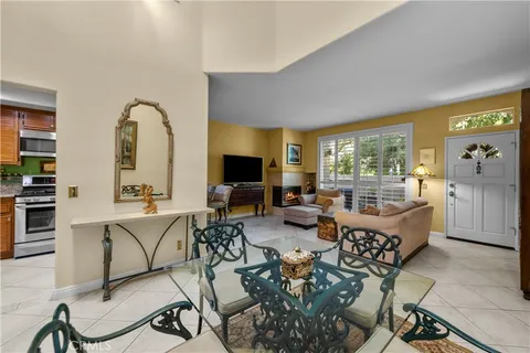 a living room with fireplace furniture and a large window