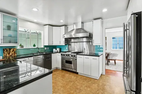 a kitchen with a table and chairs