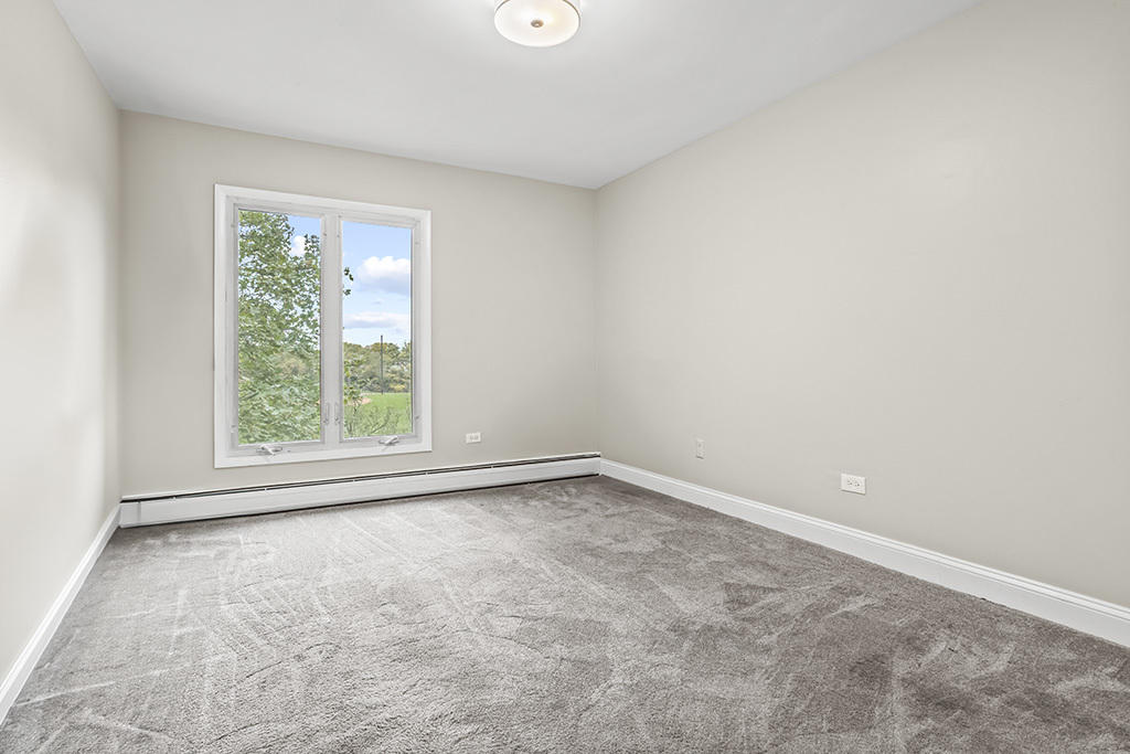 3913 Saratoga Avenue, Unit G306 Downers Grove, IL 60515 - Photo 14 of 18 an empty room with a window