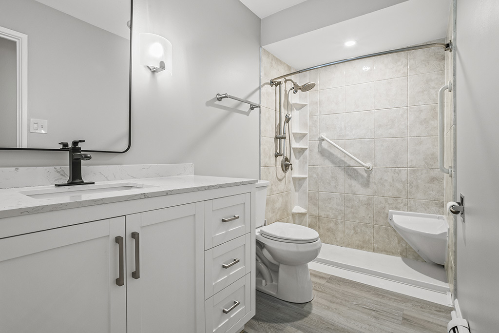 3913 Saratoga Avenue, Unit G306 Downers Grove, IL 60515 - Photo 15 of 18 a bathroom with a sink a toilet and shower