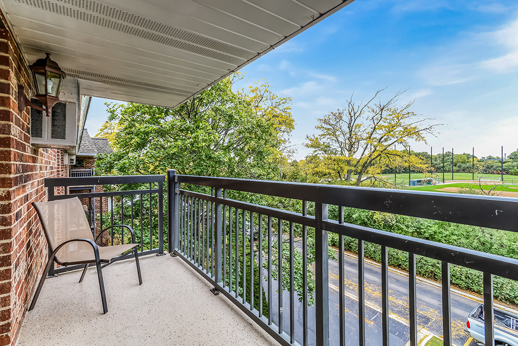 3913 Saratoga Avenue, Unit G306 Downers Grove, IL 60515 - Photo 16 of 18 a view of a chair and table in the balcony